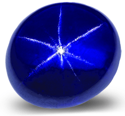 Polished blue star sapphire cabochon showing a six-rayed star