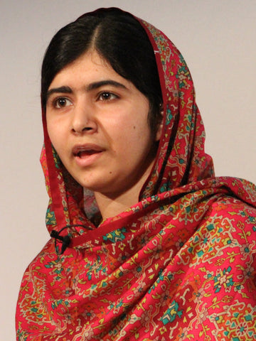 Young woman in a red patterned headscarf speaking