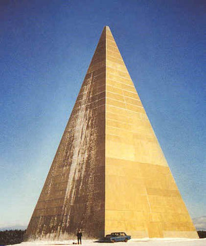 Golod's pyramid in Moscow: a tall pale fiberglass pyramid in snow with a person and car at its base